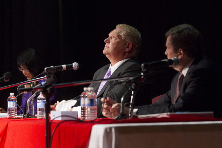 Doug Ford (centre) sits with fellow candidates Olivia Chow and John Tory as he takes part in a Toronto Mayoral Debate in Toronto on Tuesday, September 23, 2014.