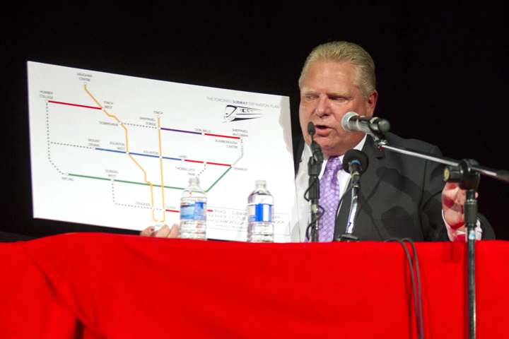 Doug Ford holds a board detailing his transit plan as he takes part in a Toronto Mayoral Debate with John Tory and Olivia Chow in Toronto on Tuesday, September 23, 2014.