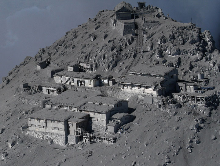 This aerial picture taken on September 28, 2014 shows mountain cottages and a Shinto shrine (above) being covered with volcanic ash on the top of Mount Ontake at Nagano prefecture, one day after Japan’s volcano Ontake erupted in central Japan, which straddling Nagano and Gifu prefecture.