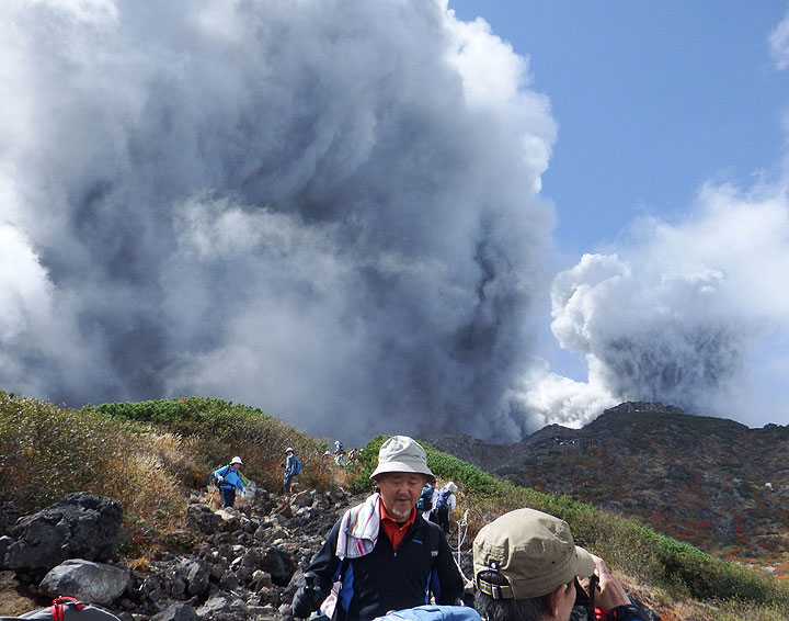 In this photo taken by an anonymous climber, climbers descend Mt. Ontake to flee as the volcanic moutain erupts in central Japan, Saturday, Sept. 27, 2014.