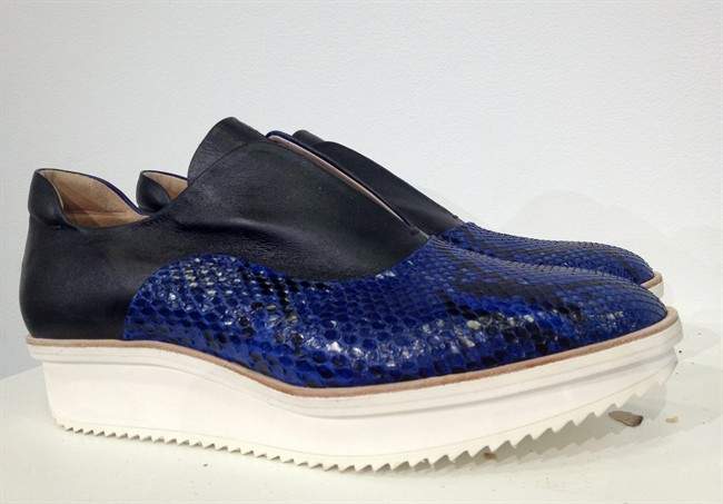 Reed Krakoff's sporty, feminine presentation Wednesday at New York Fashion Week included macrame raffia, perforation, supple leather in cobalt blue and some killer handbags.
