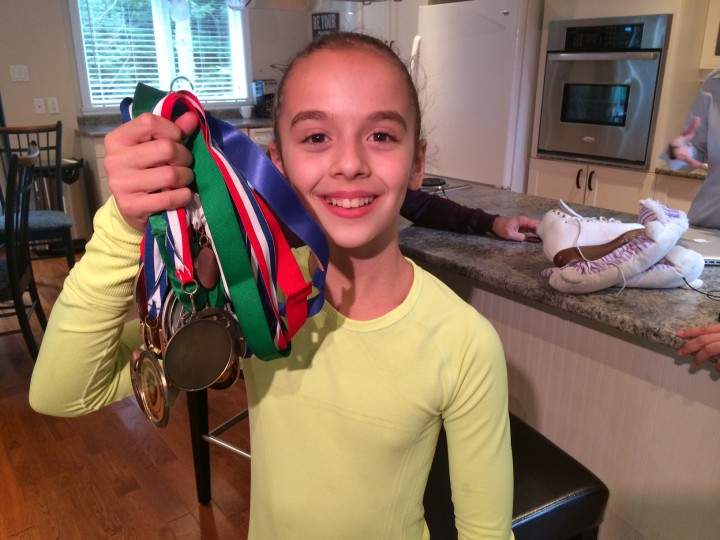 The 12-year-old figure skater shows Global News her many medals.