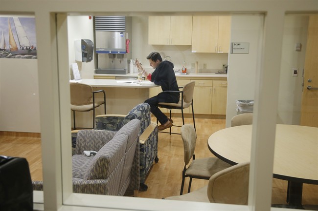 FILE - This Jan. 14, 2014 file photo shows Daniel Bennett quarantined in an isolation unit at the National Institute of Health (NIH) in Bethesda, Md., during research for a better flu vaccine.