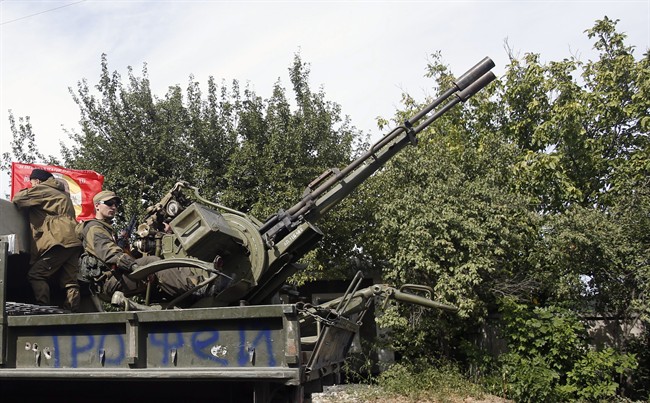 A Pro-Russian rebels truck with an anti-aircraft weapon is driven in a parade in the town of Luhansk, eastern Ukraine, Sunday, Sept. 14, 2014.