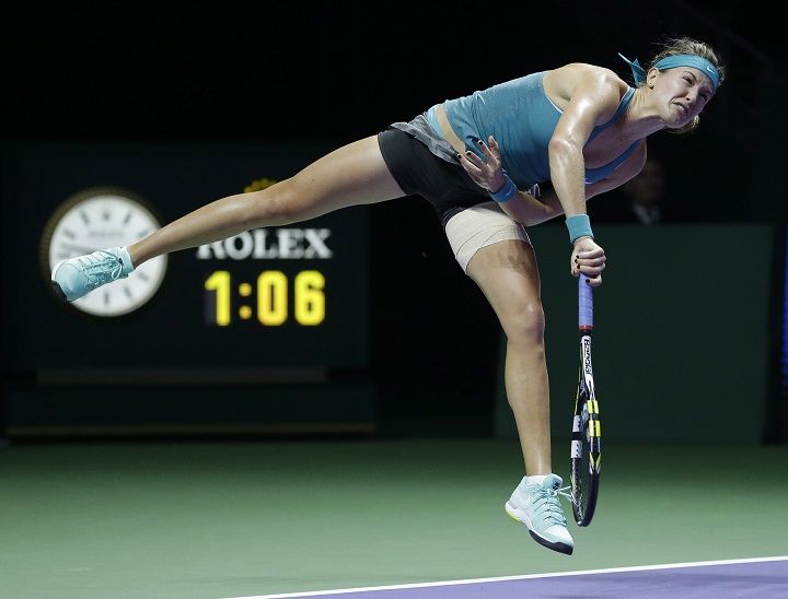 Canada's Eugenie Bouchard serves to Serbia's Ana Ivanovic during their singles match at the WTA tennis finals in Singapore,Wednesday, Oct. 22, 2014.
