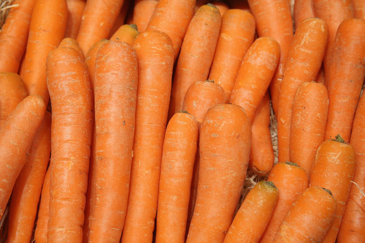 Organic carrots lie on display