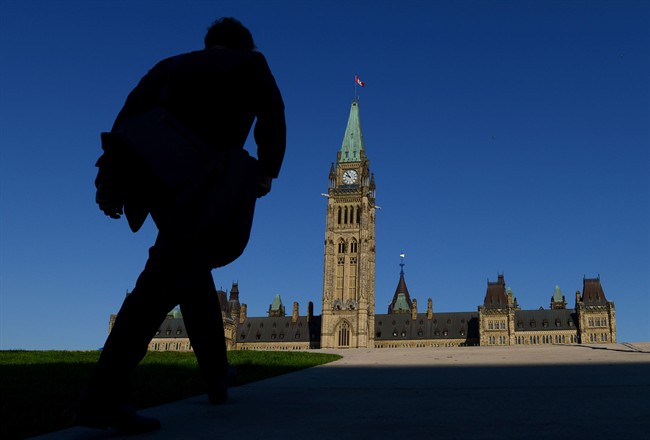 A man walks on Parliament Hill on September 15, 2014. THE CANADIAN PRESS/Sean Kilpatrick.
