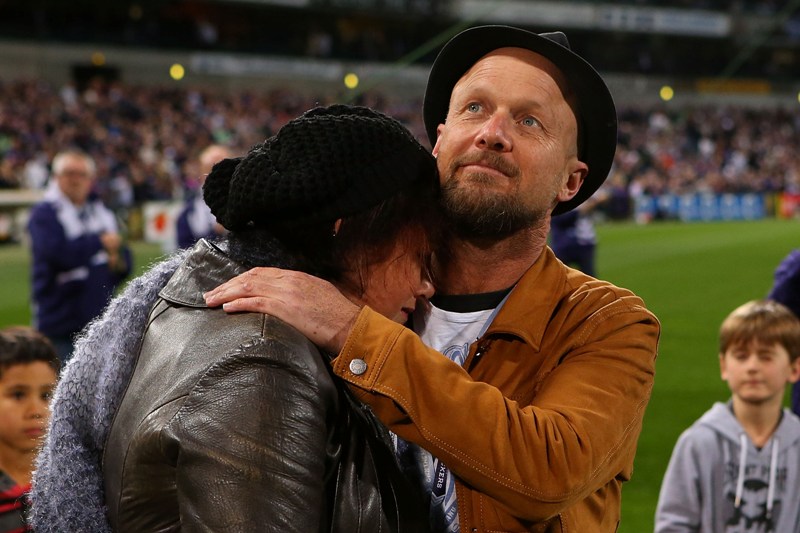 Parents of MH17 crash victims Evie, Mo and Otis Maslin, Marite Norris is comforted by Anthony Maslin after releasing balloons before an AFL match on July 31, 2014 in Perth, Australia. 