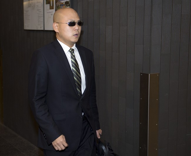 Dong Dong Xu, a friend of victim Jun Lin, arrives to testify at the murder trial for Luka Magnotta Tuesday, Oct. 7, 2014 in Montreal.