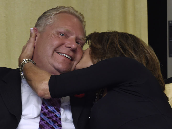 Doug Ford gets a hug from his wife Karla at his mother’s home in Toronto Monday, Oct. 27, 2014 after the civic election was called.