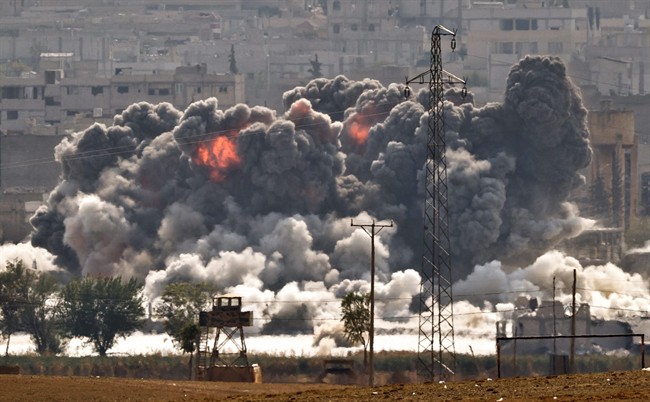 Smoke and flames rise from an Islamic State fighters' position in the town of Kobani during airstrikes by the US led coalition seen from the outskirts of Suruc, near the Turkey-Syria border, Tuesday, Oct. 28, 2014. 