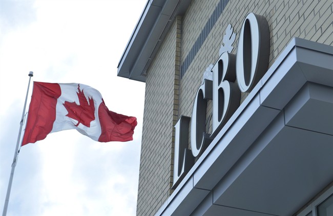 A Canadian flag flies near a LCBO store in Bowmanville, Ontario on Saturday July 20, 2013. THE CANADIAN PRESS/Doug Ives.
