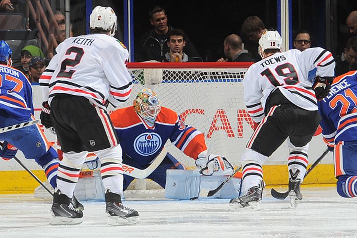 Ben Scrivens #30 of the Edmonton Oilers makes a save on a shot from Jonathan Toews #19 of the Chicago Blackhawks on November 22, 2014 at Rexall Place in Edmonton, Alberta, Canada. 