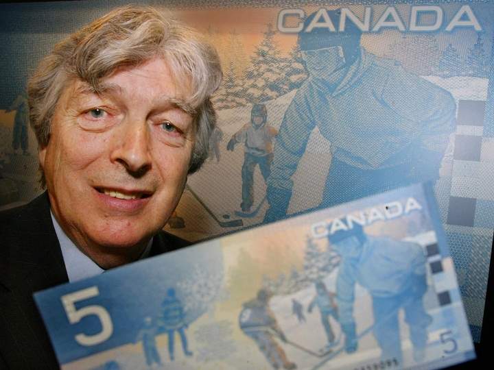 Author Roch Carrier poses with a new Canadian five dollar bill during an unveiling ceremony in Montreal, Wednesday, March 27, 2002.