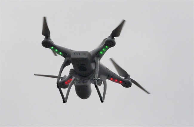  In this March 12, 2014 file photo, a drone flies over the scene of an explosion that leveled two apartment buildings in the East Harlem neighborhood of New York. The government has the power to hold drone operators accountable when they operate the remote-control aircraft recklessly, a federal safety board ruled Tuesday in a setback to small drone operators chafing under Federal Aviation Administration restrictions. 