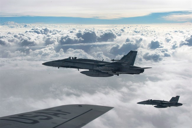 Royal Canadian Air Force CF-18 Hornets, above, in October 2014, over Iraq.