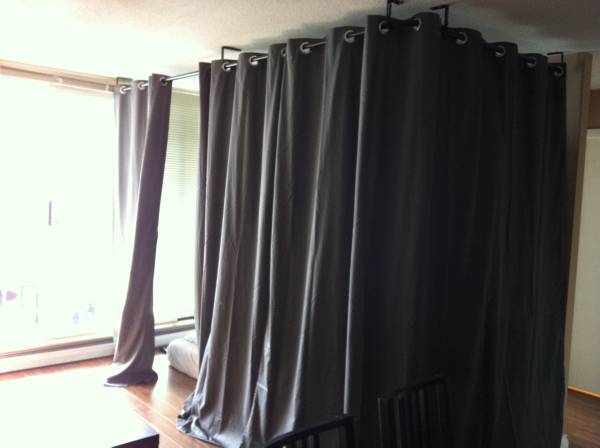 This curtained-off space in a living room is available for $630 a month.