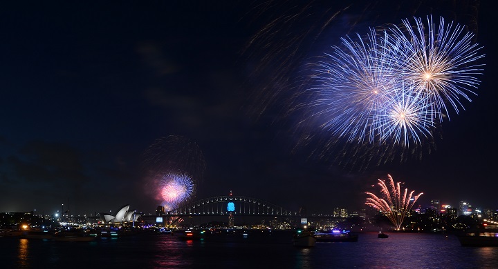 New Year’s Eve fireworks erupt over Sydney’s iconic Harbour Bridge and Opera House (bottom L) during the traditional early family fireworks show held before the main midnight event on December 31, 2014.