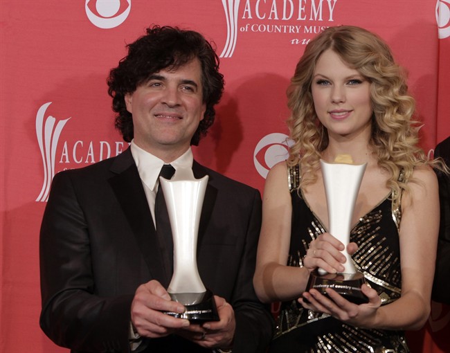 In this April 5, 2009 file photo, producer Scott Borchetta, left, and Taylor Swift pose with the Album of the Year award at the 44th Annual Academy of Country Music Awards in Las Vegas, Nev.