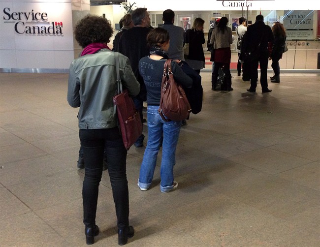 People wait for a Service Canada centre to open on April 2, 2014 in Montreal.