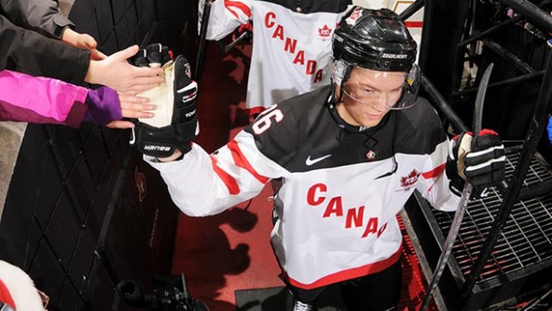 Curtis Lazar giving high fives to fans.