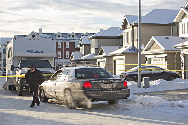 Police investigate the scene where multiple deaths occurred in a north Edmonton home overnight in Edmonton, Alberta on Tuesday, December 30, 2014. THE CANADIAN PRESS/Jason Franson.