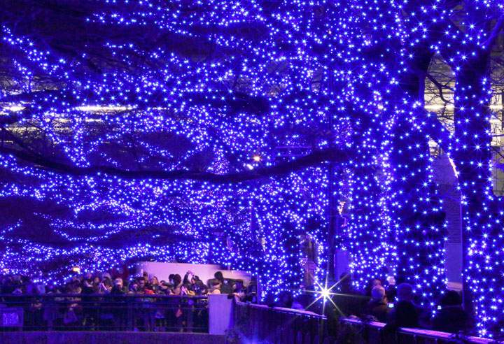 People gather along the Meguro River to watch Christmas decorations done with LED lights in Tokyo, Friday, Dec. 12, 2014. An annual Christmas decoration drew thousands of visitors in the suburb of the capitol.