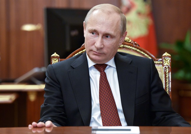 Russian President Vladimir Putin meets with Russia's chief rabbi Berel Lazar and Chairman of Federation of Russia's Jewish Organizations Alexander Boroda in the Kremlin in Moscow, Russia, Wednesday, Dec. 17, 2014.