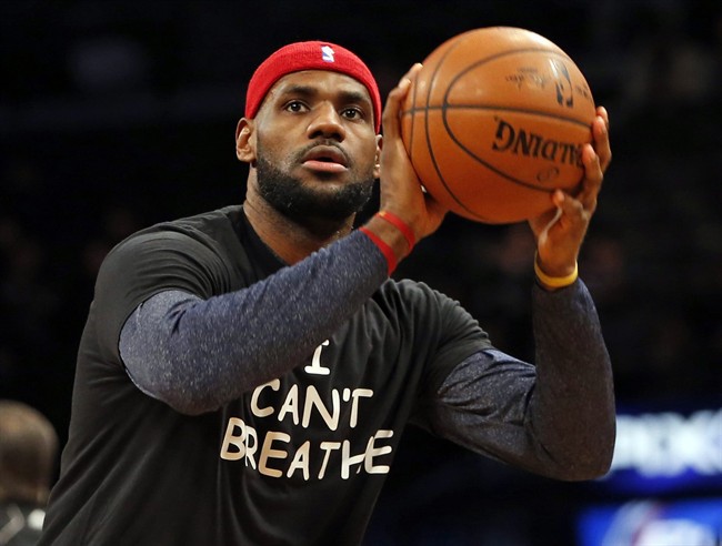 LeBron James warms up before an NBA basketball game against the Brooklyn Nets at the Barclays Center, Monday, Dec. 8, 2014, in New York. Professional athletes have worn “I Can’t Breathe” messages in protest of a grand jury ruling not to indict an officer in the death of a New York man. (AP Photo/Kathy Willens)