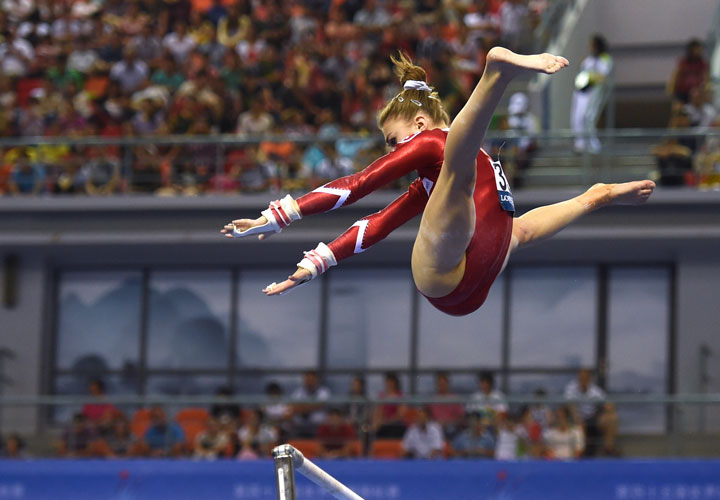 Switzerland’s Ilaria Kaeslin performs on the uneven bars during the women’s qualification at the Gymnastics World Championships in Nanning, in China’s southern Guangxi province on October 5, 2014.