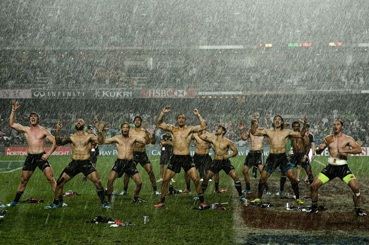 New Zealand players perform the “haka” in the rain after their victory over England in the final match of the three-day rugby sevens tournament at Hong Kong Stadium on March 30, 2014.