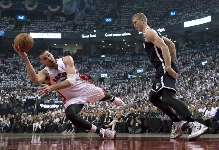 Toronto Raptors centre Jonas Valanciunas gets off a shot while tumbling during the first half of NBA playoff action in Toronto on Tuesday April 22, 2014.