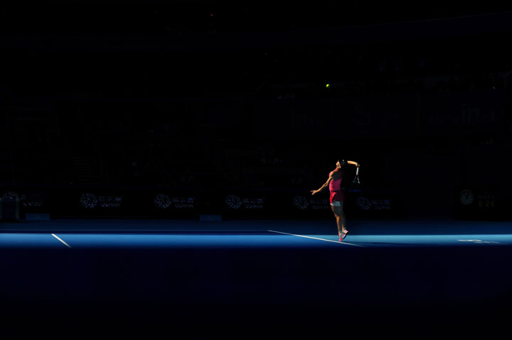 Simona Halep serves against Andrea Petkovic during their women’s singles third round match at the China Open in the National Tennis Center of Beijing on October 2, 2014.