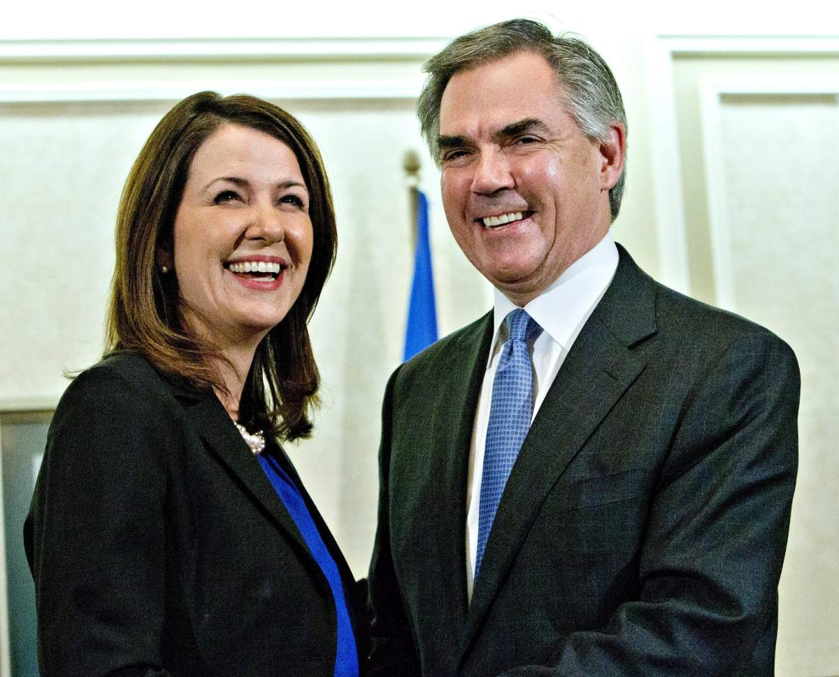 Alberta Premier Jim Prentice and former Wildrose Leader Danielle Smith speak to media after a caucus meeting in Edmonton Alta., Wednesday, December 17, 2014. Prentice's caucus met to discuss a bid by at least half the official Opposition to cross the floor.