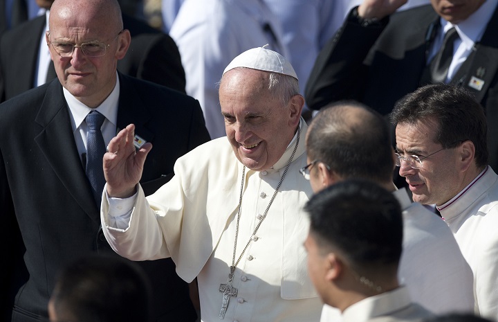 Pope Francis (C) waves to the crowd during a departure ceremony at Villamor Airbase in Manila on January 19, 2015.  Pope Francis flew back to Rome on January 19 after a dramatic week in Asia that saw him draw record crowds and hammer home his pro-poor message to millions.