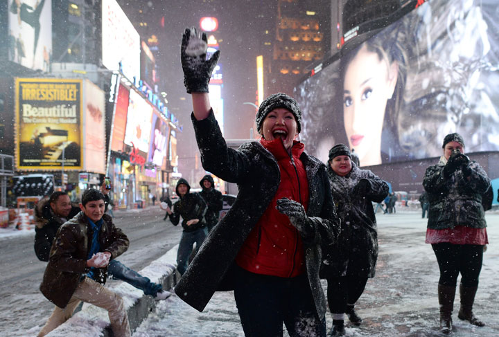 A group of teens from Texas play snow-ball-fighting on a deserted street in New York’s Times Square during a snow storm on January 26, 2015.