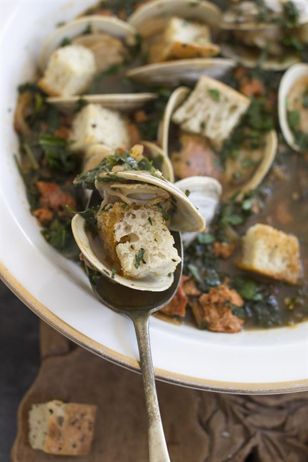 This Jan. 5, 2015 photo shows spicy clam and kale soup in Concord, N.H. Tucked away between the tofu “cheeses” and textured vegetable protein taco crumbles lies a good go-to and good-for-you ingredient, soy chorizo.