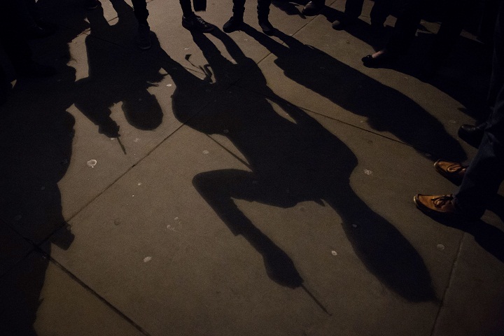 Shadows of people holding pens in the air at a gathering in Trafalgar Square in central London to show their respect for the twelve people killed in Paris today in a terrorist attack at the headquarters of satirical publication “Charlie Hebdo” on January 7, 2015.