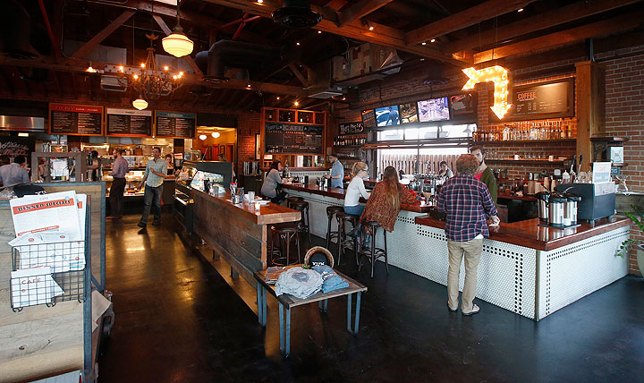 In this Jan. 14, 2015 photo, diners are served at the counter at the Phoenix Public Market Cafe restaurant in Phoenix. The Super Bowl takes place Feb. 1 in nearby Glendale, Ariz., and the restaurant scene in downtown Phoenix sees the game as an opportunity to show off its creative local cuisine.