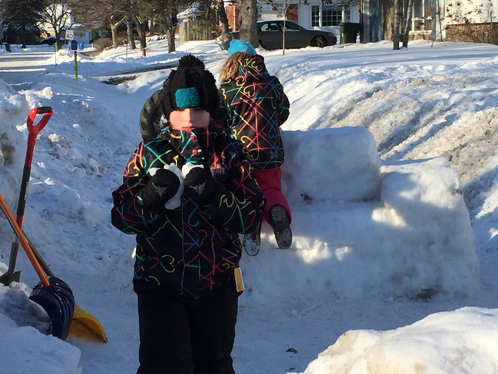 Children play in the Beaconsfield snow fort that city officials are asking to be removed or moved for safety reasons.