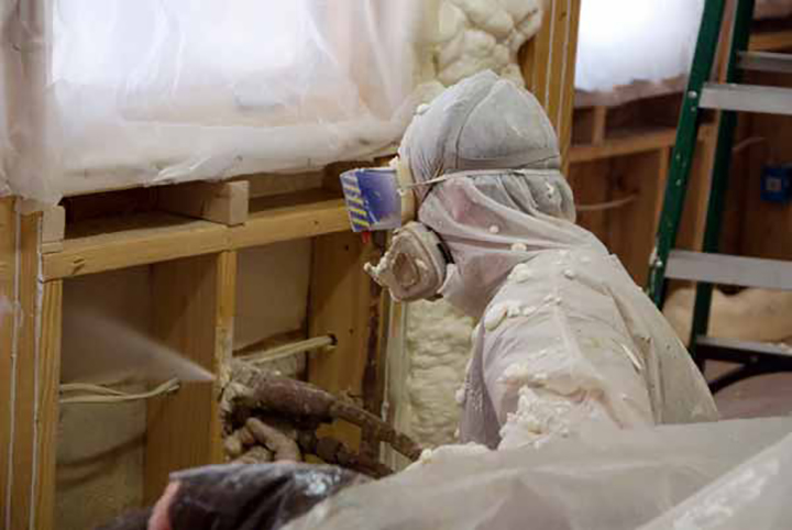 Spray foam being applied to a wall.