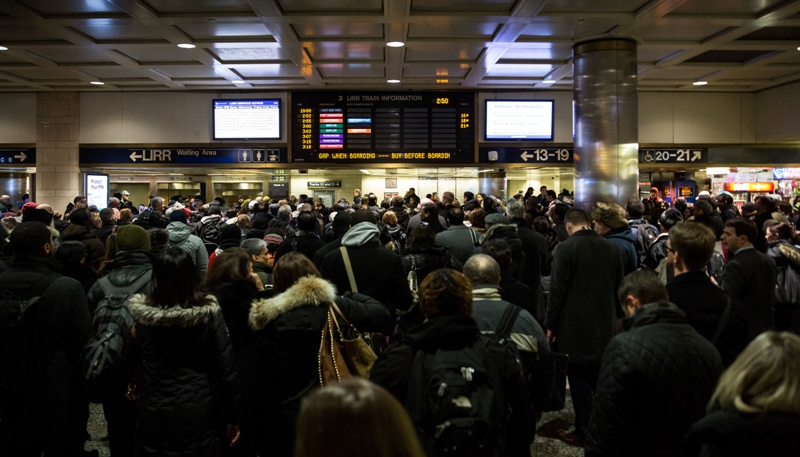 People wait for their train platform to be announced at Penn Station while a major snowstorm begins on January 26, 2015 in New York City.