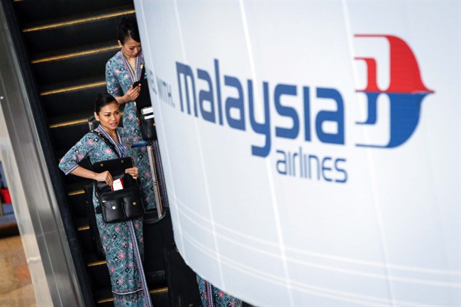 Malaysia Airlines flight crew members head for the the departure lounge at Kuala Lumpur International Airport, in Malaysia, Thursday, Jan. 29, 2015. 