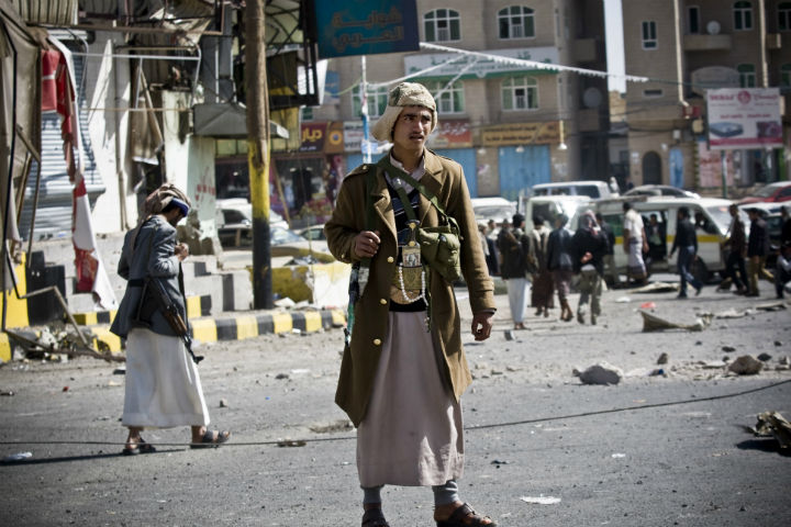 Houthi Shiite Yemeni gather while guarding a street leading to the presidential palace in Sanaa, Yemen, on Tuesday.