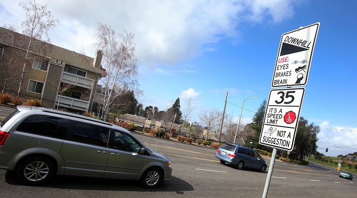 In this Feb. 9, 2015 photo, a new traffic sign sits along Hayward Boulevard in Hayward, Calif. The city is using humor to get drivers to slow down and pedestrians to pay attention.