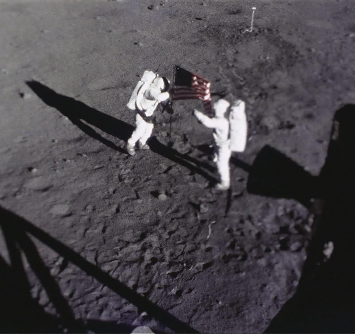 Camera view of Neil and Buzz setting the American Flag