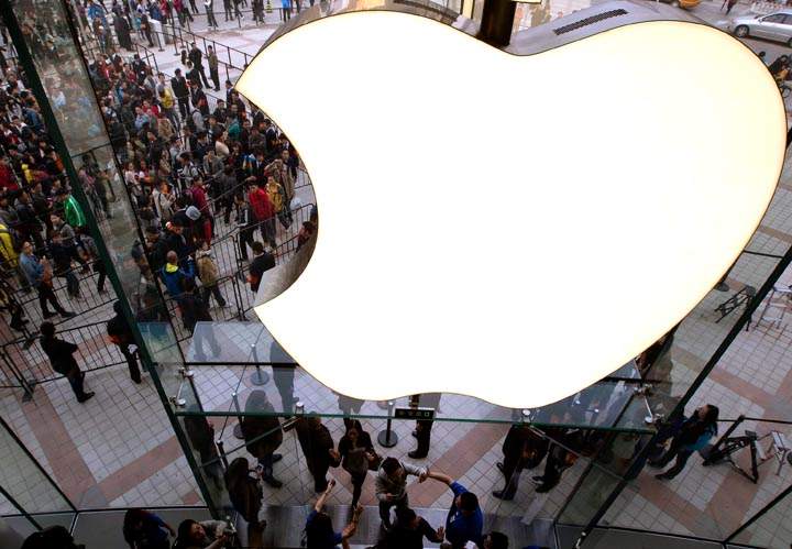 Employees cheer customers as they enter a newly opened Apple Store in the Wangfujing shopping district in  Beijing, Oct. 2012.