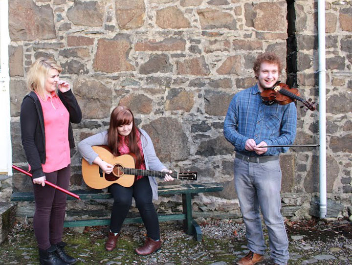 Caitlin McNeill, seated with guitar, posted the photo that has gone viral.