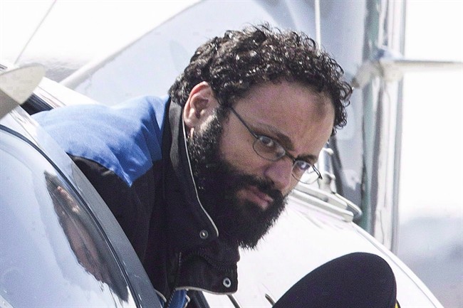 Chiheb Esseghaier, accused of plotting a terror attack on a rail target, is led off a plane by an RCMP officer at Buttonville Airport, just north of Toronto, on Tuesday, April 23, 2013. 