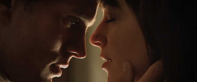 Jamie Dornan, left, and Dakota Johnson appear in a scene from "Fifty Shades of Grey" in this image released by Universal Pictures and Focus Features. THE CANADIAN PRESS/AP-Universal Pictures and Focus Features.